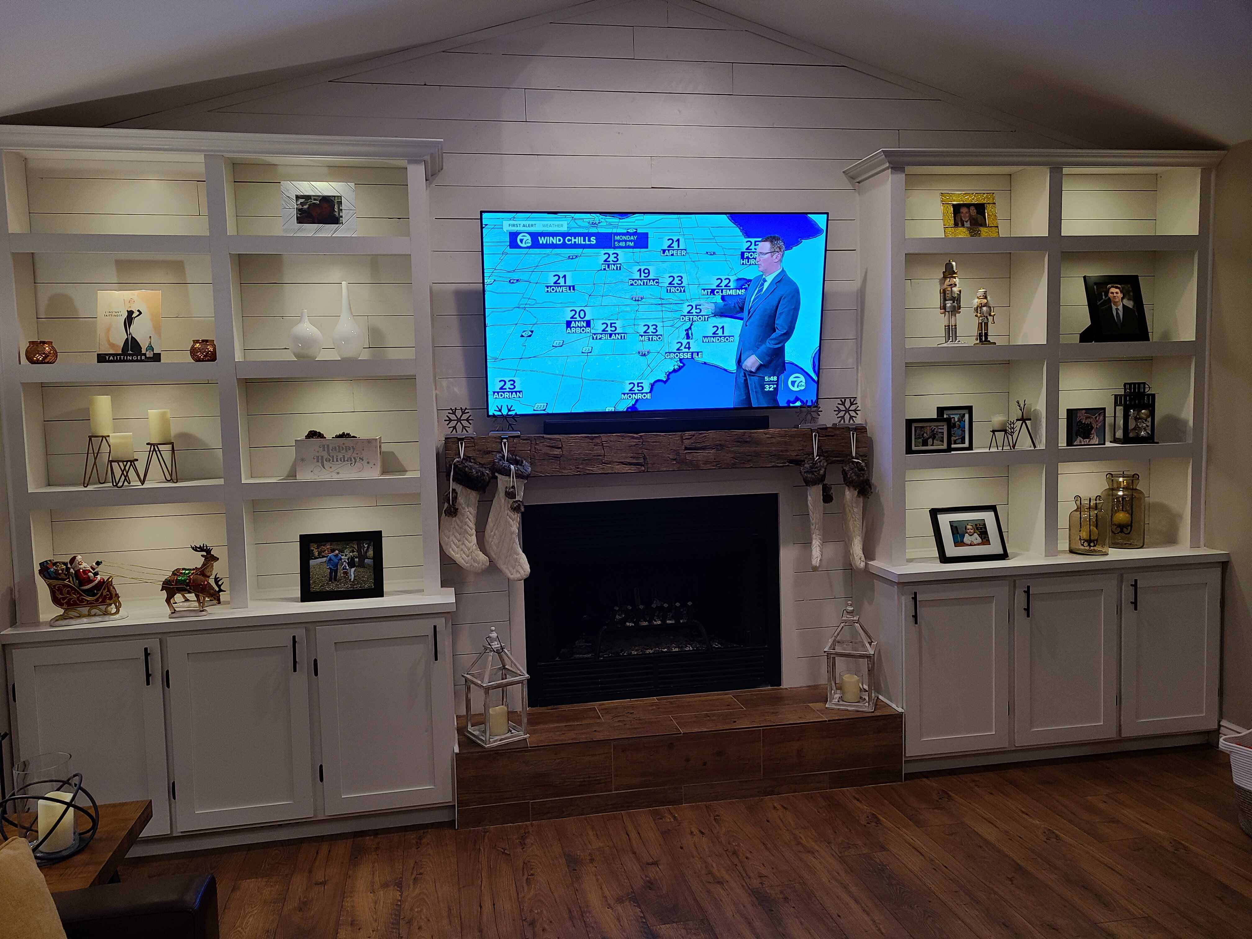A living room with a custom shelf unit.